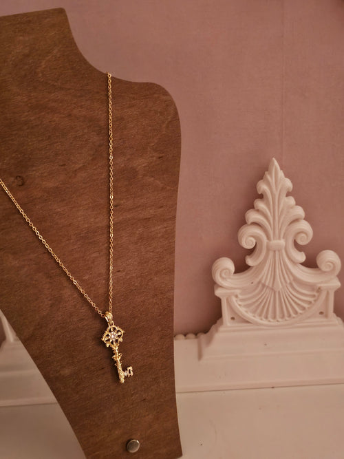Gold necklace with gold key pendant