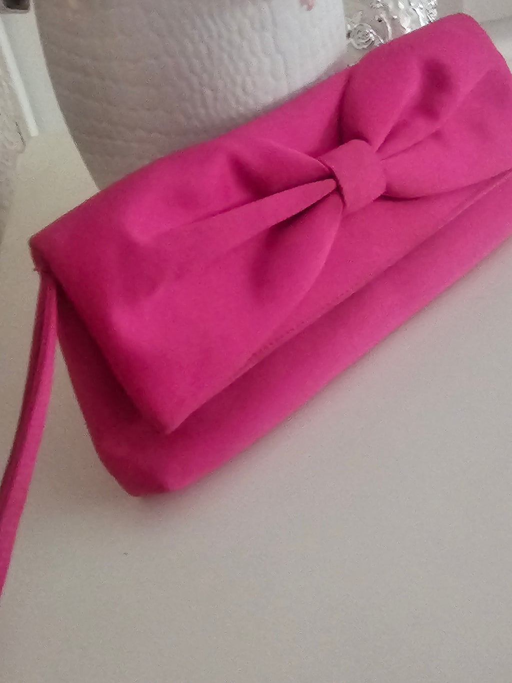 Ladies Pink fascinator with matching clutch bag