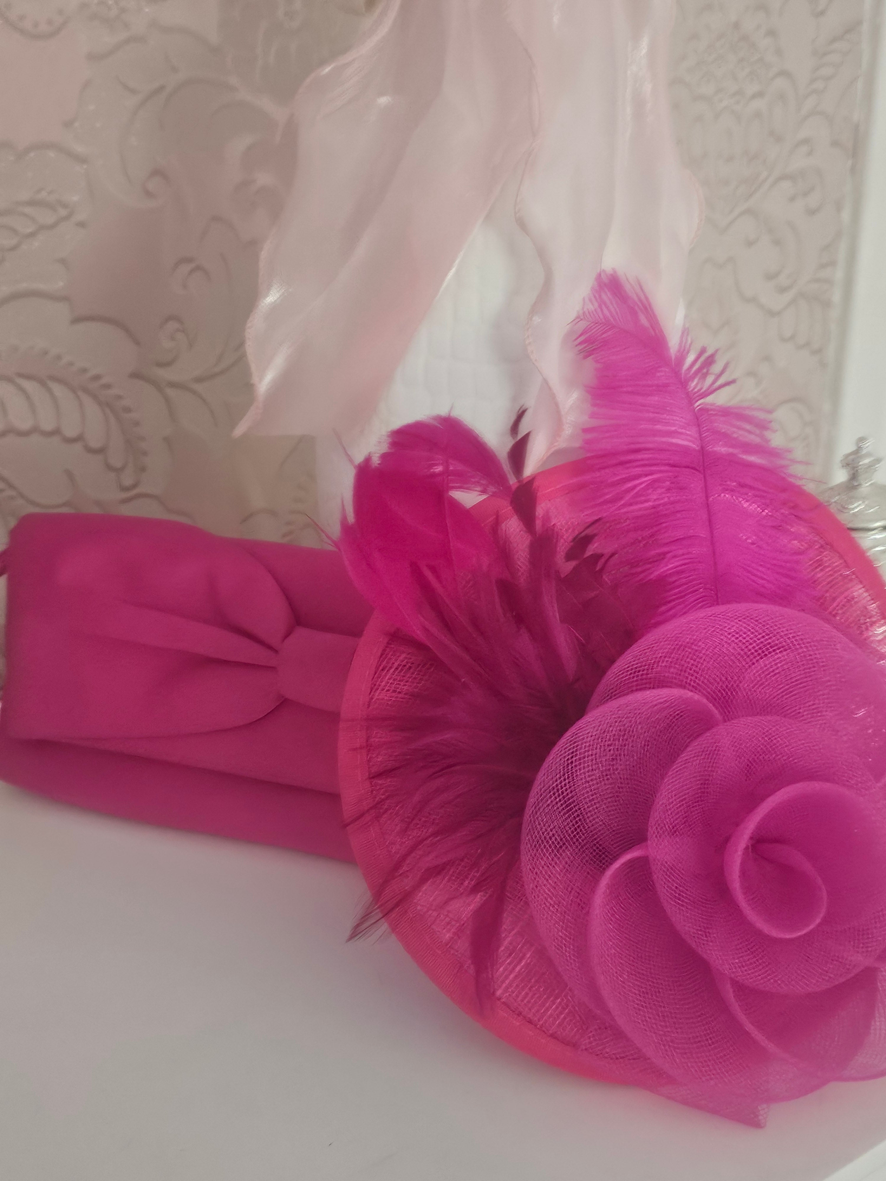 Ladies Pink fascinator with matching clutch bag