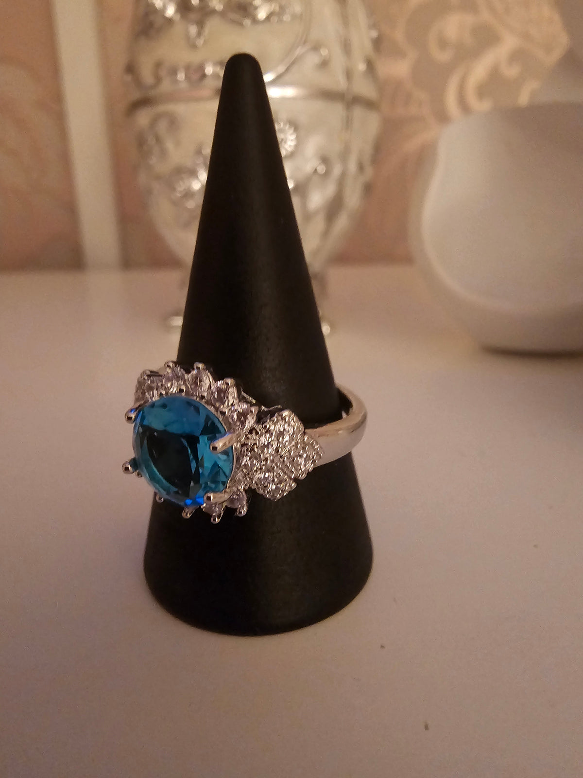 Ladies silver dress ring with blue sapphire stone setting design