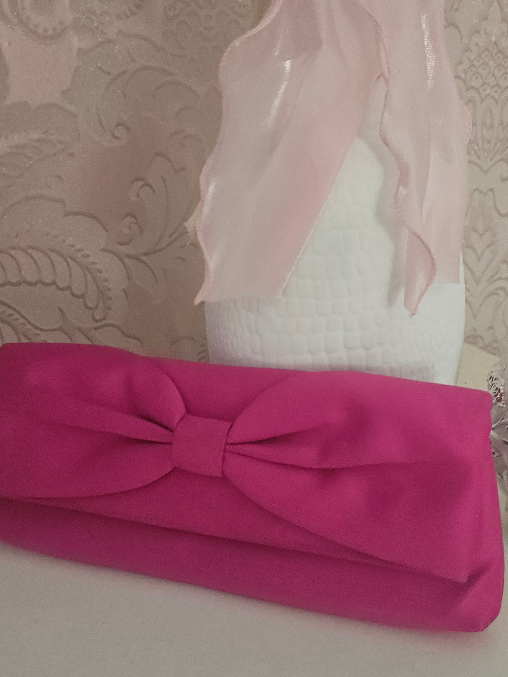 Ladies Pink fascinator with matching clutch bag