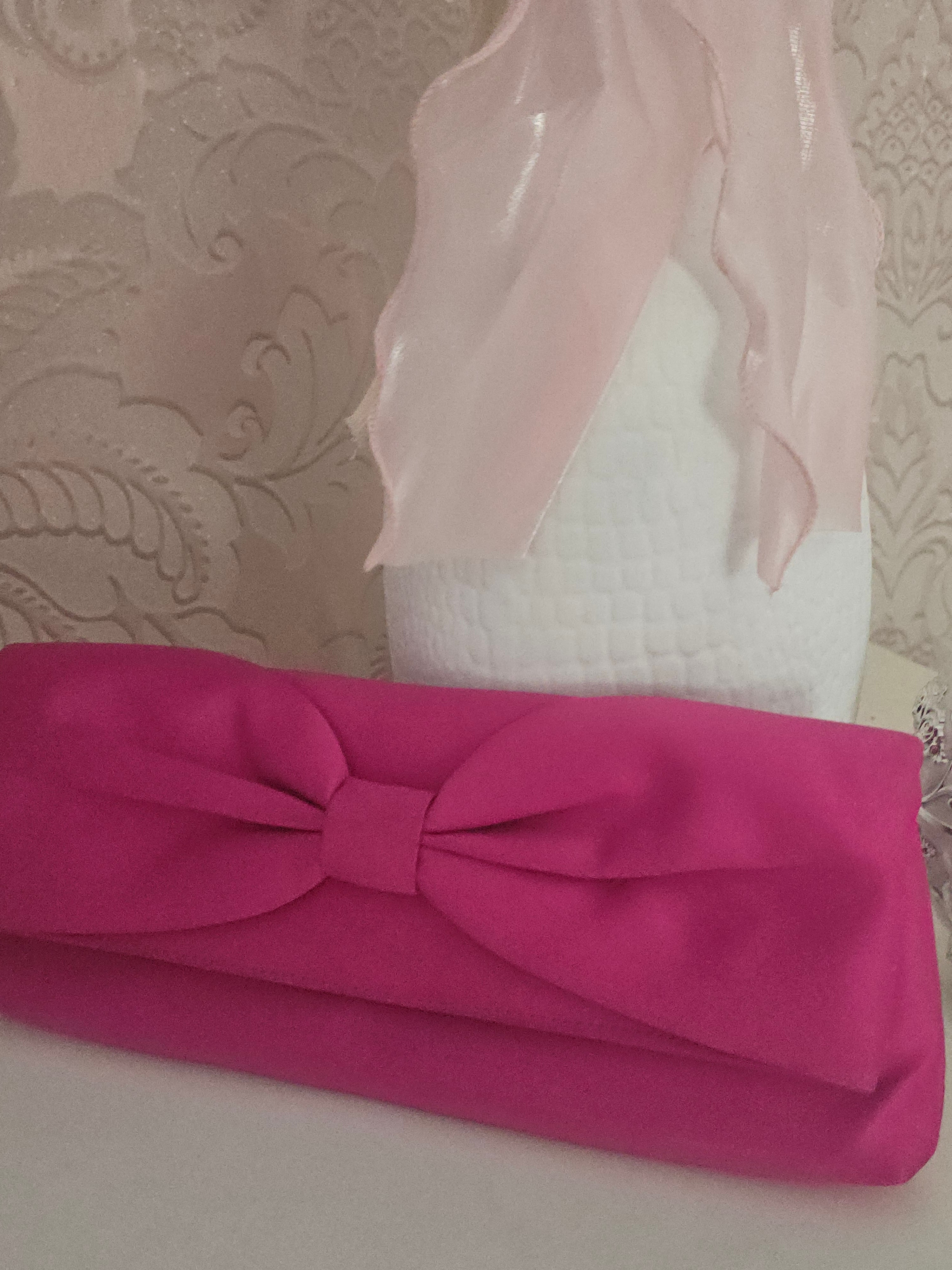 Ladies Pink fascinator with matching clutch bag
