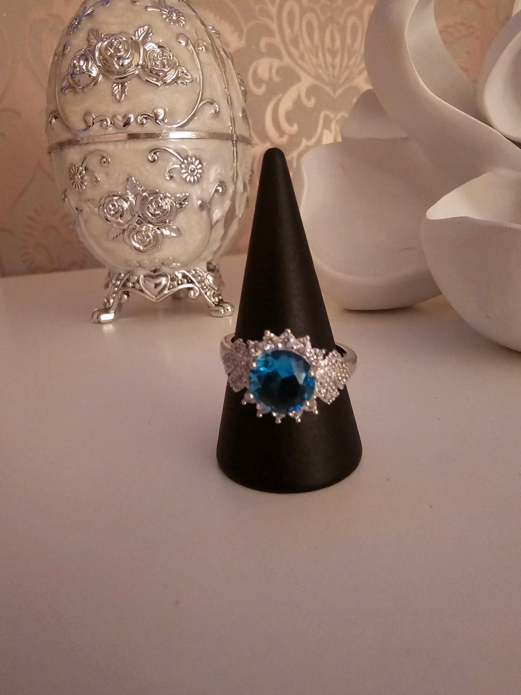 Ladies silver dress ring with blue sapphire stone setting design