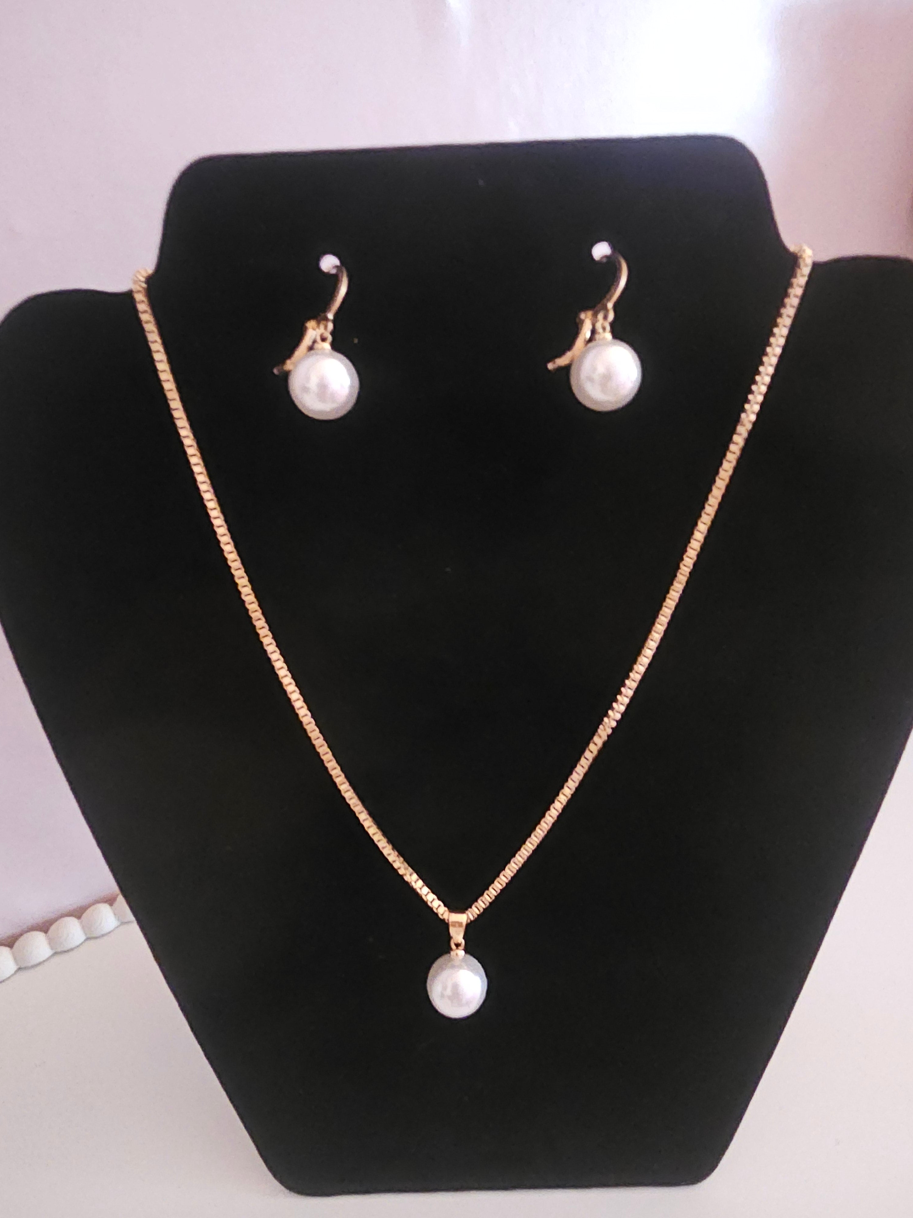 Ladies matching gold necklace with pearl drop pendant and matching pearl drop earrings