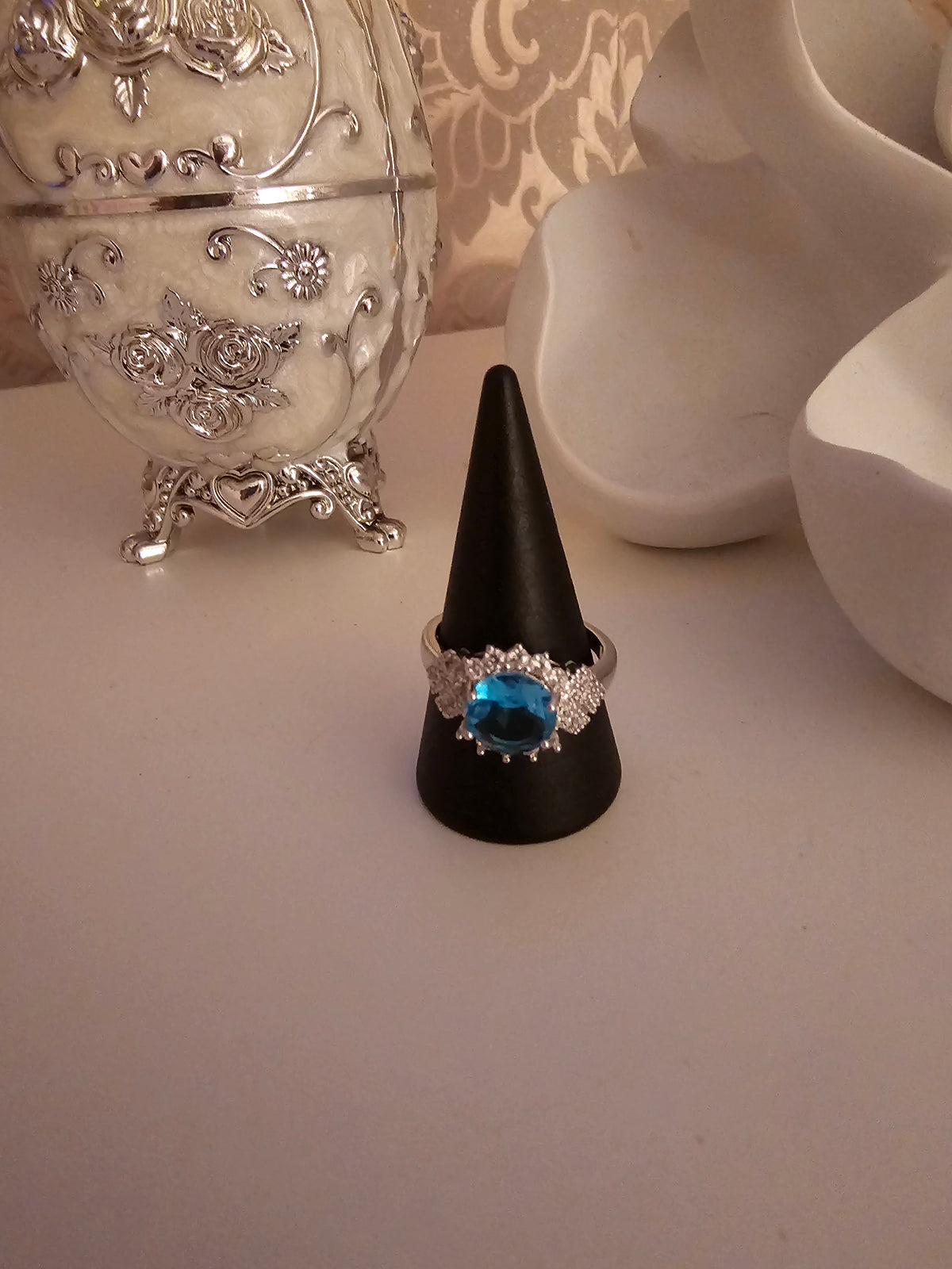 Ladies silver dress ring with blue sapphire stone setting design