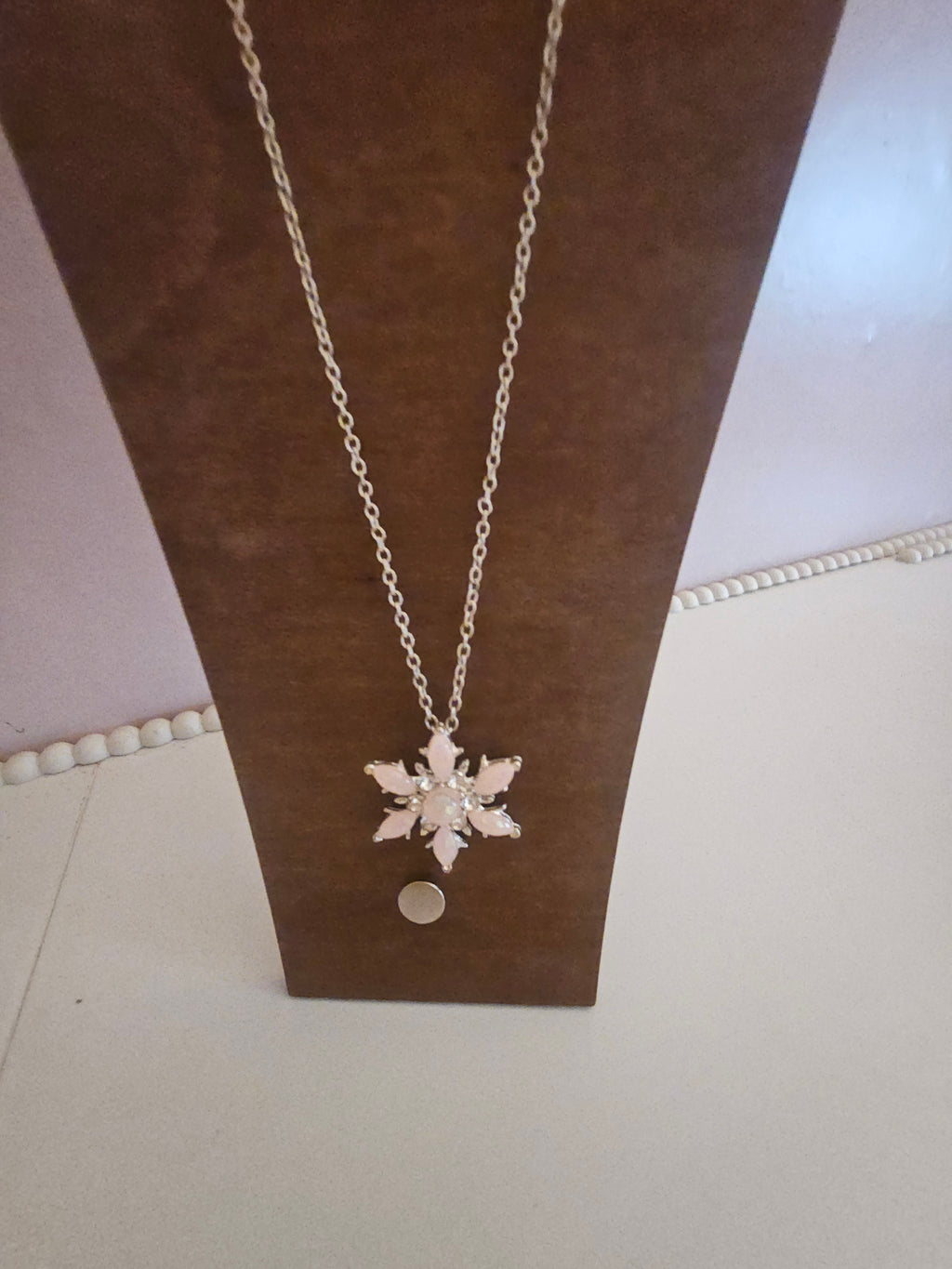 Ladies pink snowflake pendant on silver necklace