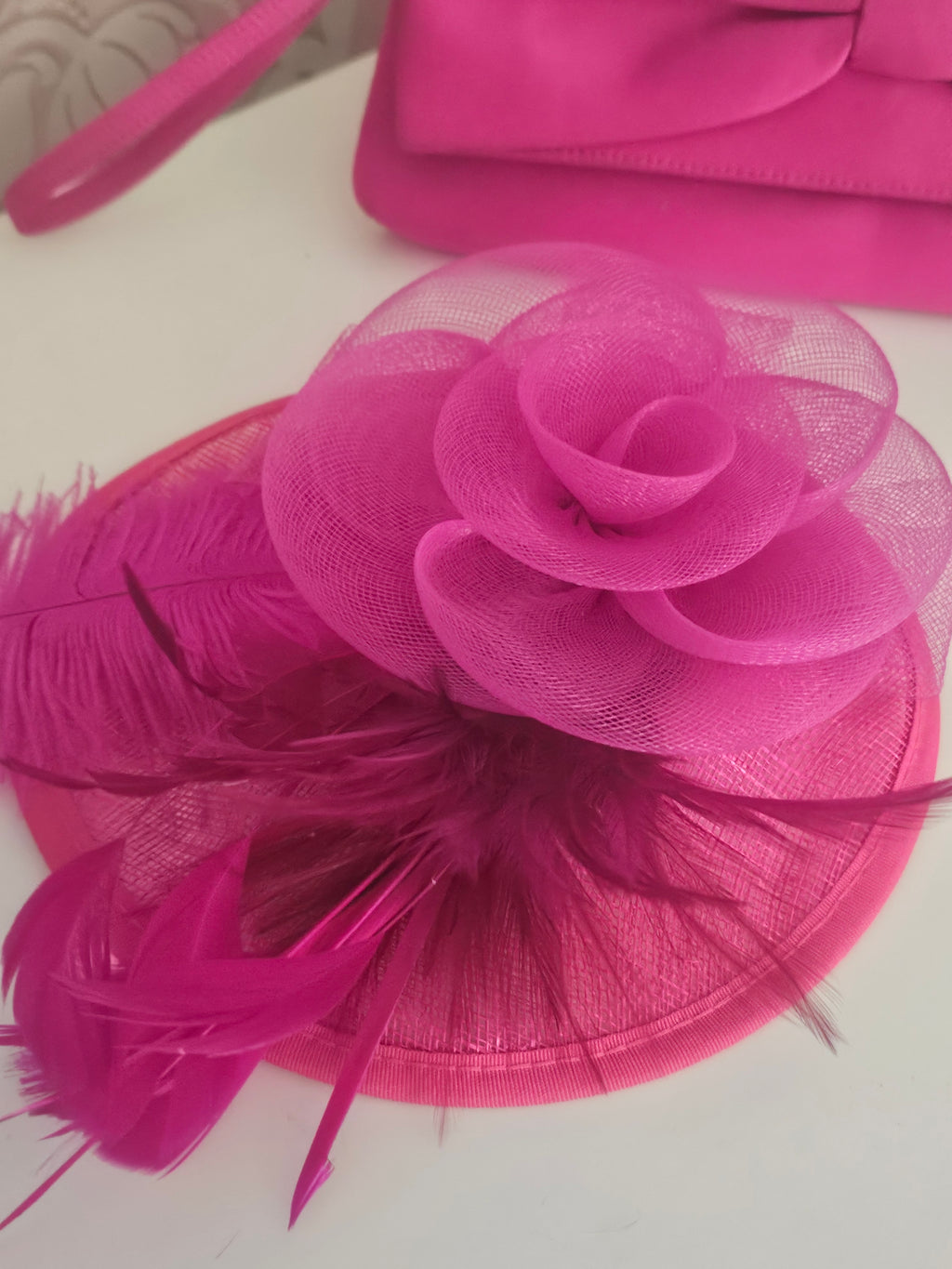 Ladies Pink fascinator with matching clutch bag