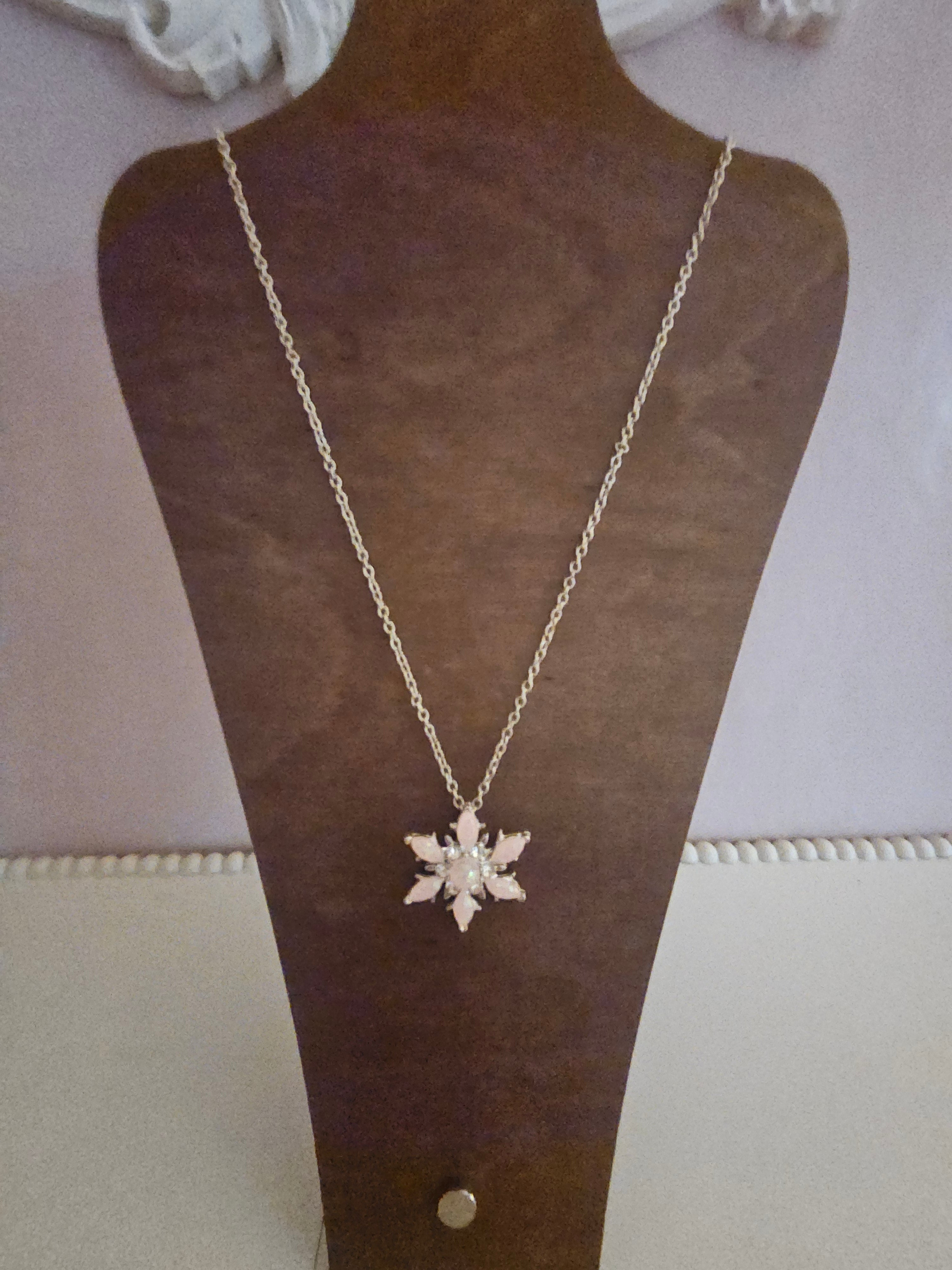 Ladies pink snowflake pendant on silver necklace