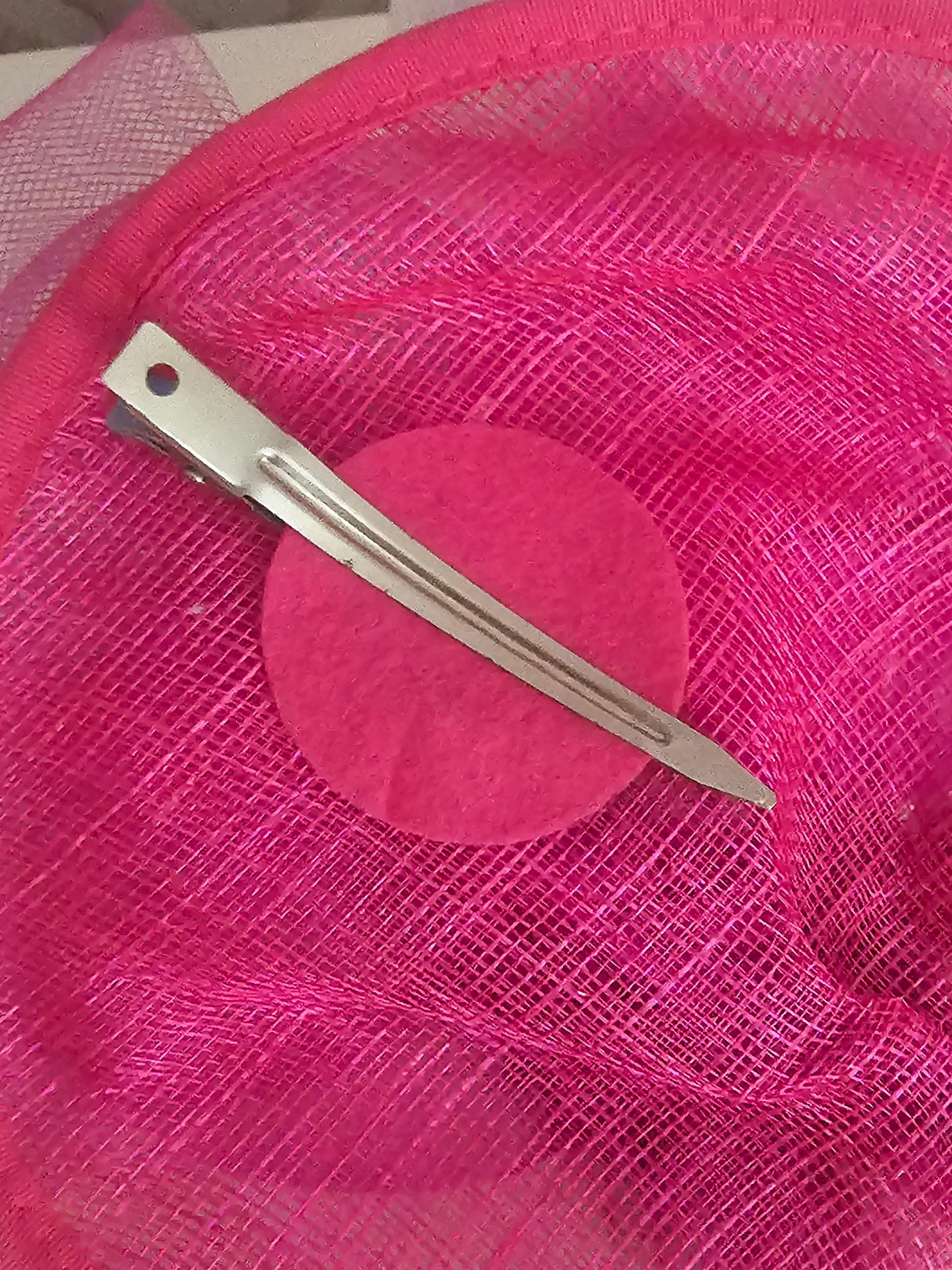Ladies Pink fascinator with matching clutch bag